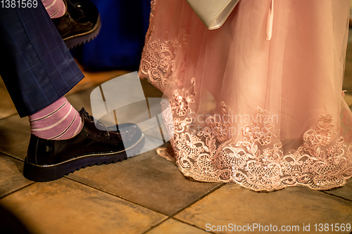 Image of Bride and groom legs on floor