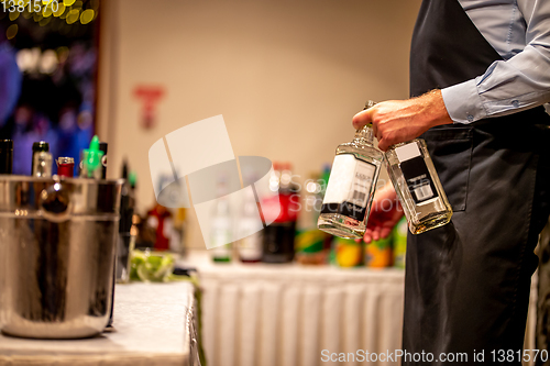 Image of Waiter with whiskey bottles in wedding