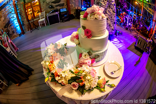 Image of Decorated wedding cake on the table.