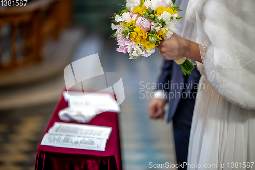 Image of Bouquet of flowers in the hand of the bride during the marriage 