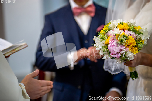 Image of Bouquet of flowers in the hand of the bride during the marriage 