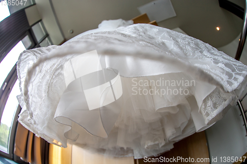 Image of Bridal dress hanging at wooden closet