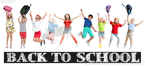 Image of Group of elementary school kids jumping, back to school