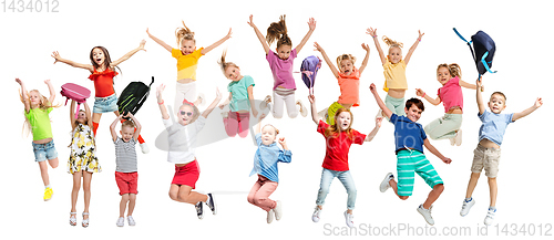 Image of Group of elementary school kids jumping, back to school