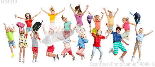 Image of Group of elementary school kids jumping, back to school