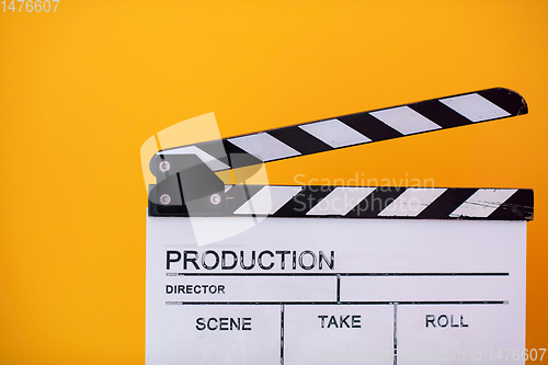 Image of movie clapper on yellow background