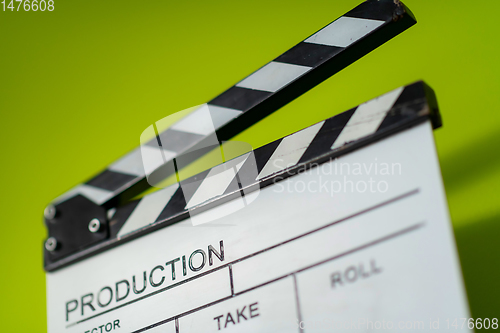 Image of movie clapper on green  background