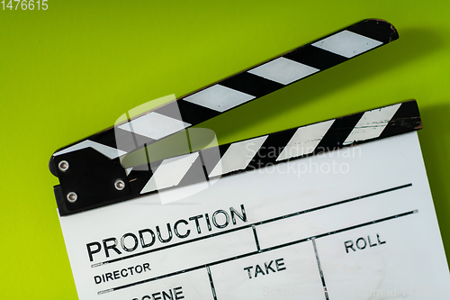 Image of movie clapper on green  background