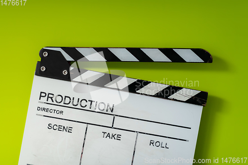 Image of movie clapper on green  background