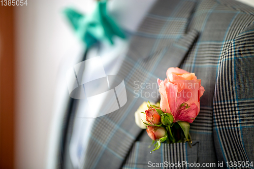 Image of Pink rose in the groom's in pocket of jacket