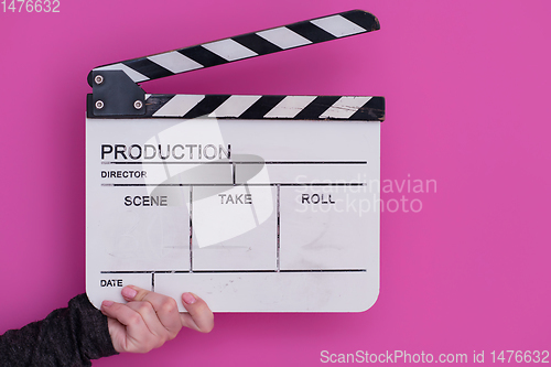 Image of movie clapper on pink background