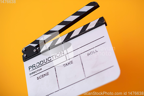 Image of movie clapper on yellow background