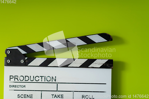 Image of movie clapper on green  background