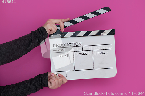 Image of movie clapper on pink background