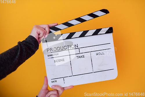 Image of movie clapper on yellow background