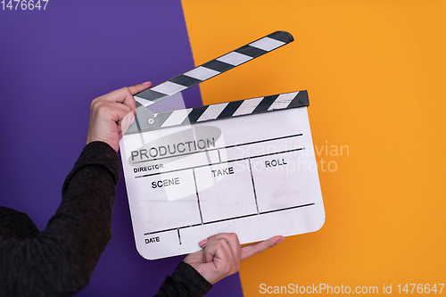 Image of movie clapper on purple background