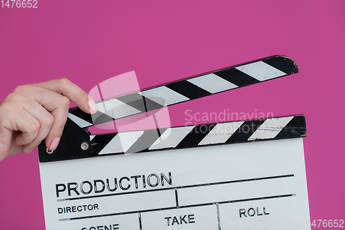 Image of movie clapper on pink background