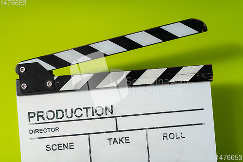 Image of movie clapper on green  background