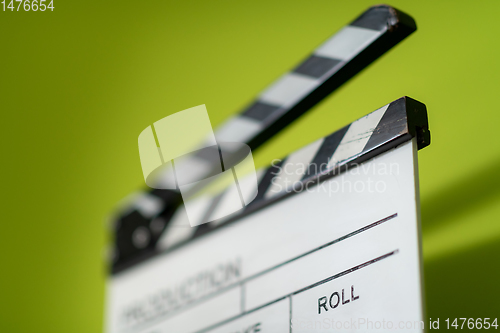 Image of movie clapper on green  background