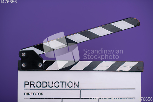 Image of movie clapper on purple background