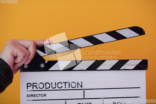 Image of movie clapper on yellow background