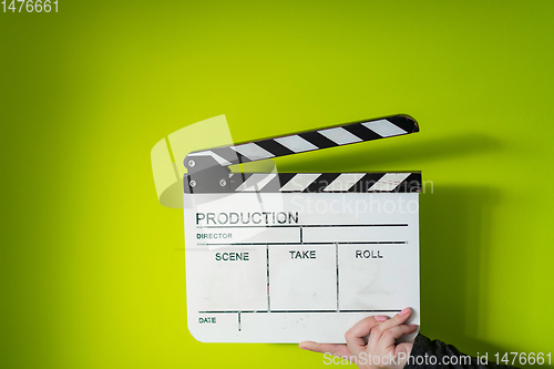 Image of movie clapper on green  background