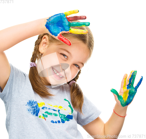 Image of Portrait of a cute girl playing with paints