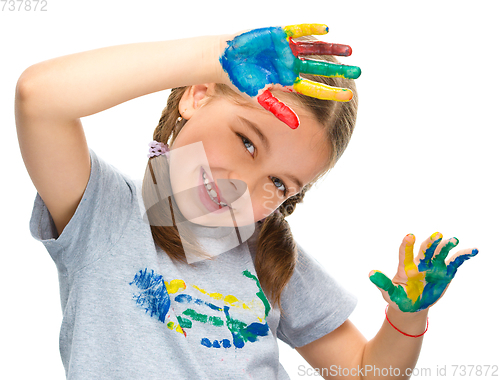 Image of Portrait of a cute girl playing with paints