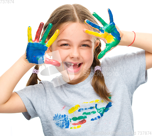 Image of Portrait of a cute girl playing with paints