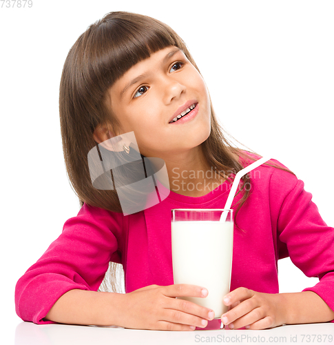 Image of Cute little girl with a glass of milk