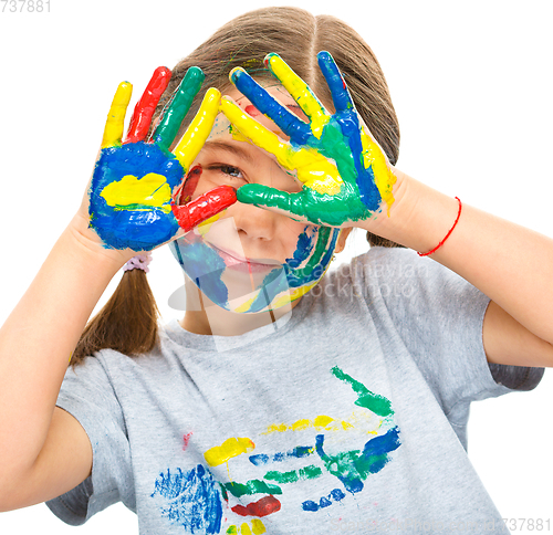 Image of Portrait of a cute girl playing with paints