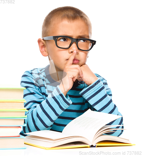 Image of Little boy is reading a book