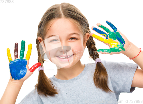 Image of Portrait of a cute girl playing with paints