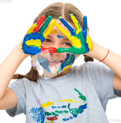 Image of Portrait of a cute girl playing with paints