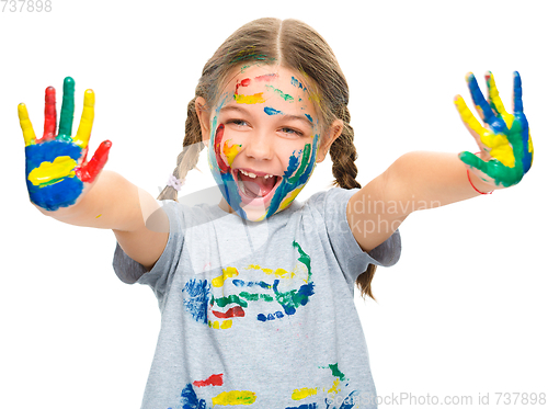 Image of Portrait of a cute girl playing with paints