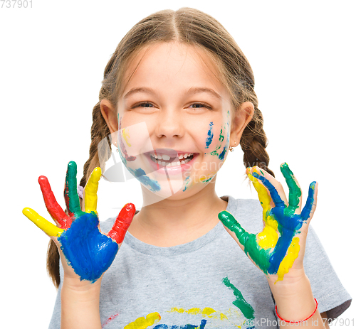 Image of Portrait of a cute girl playing with paints