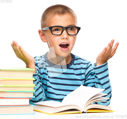 Image of Little boy is reading a book