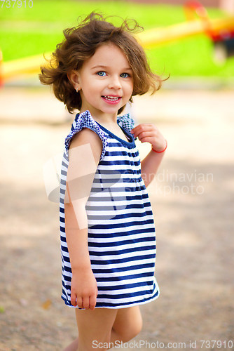 Image of Cute little girl is playing in playground