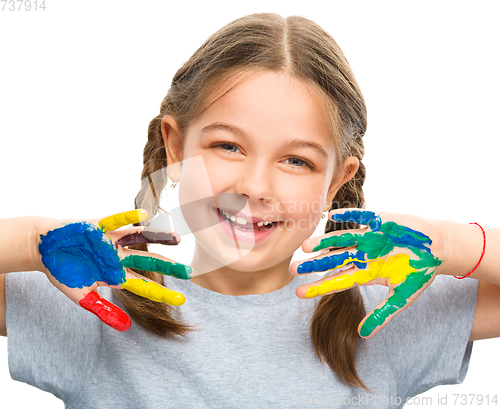 Image of Portrait of a cute girl playing with paints