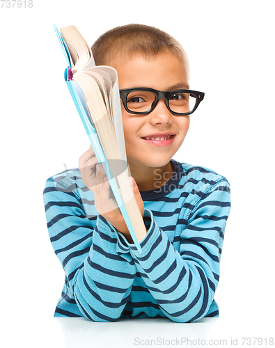 Image of Little boy is reading a book