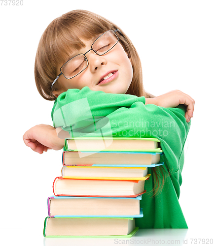 Image of Little girl is sleeping on her books