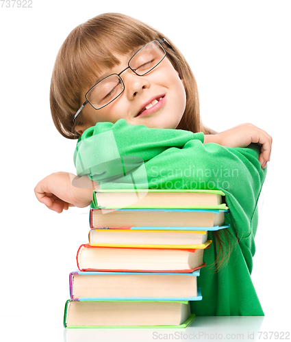 Image of Little girl is sleeping on her books