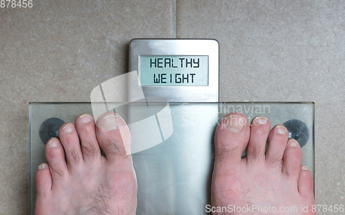 Image of Man\'s feet on weight scale - Healthy weight