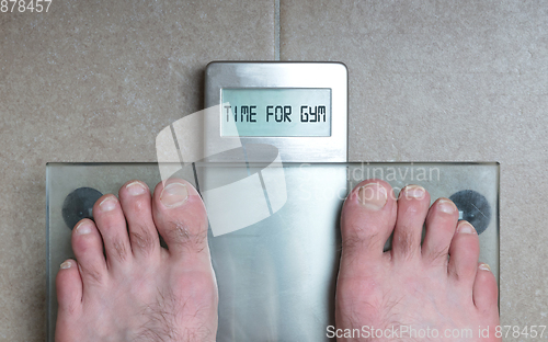 Image of Man\'s feet on weight scale - Time for gym