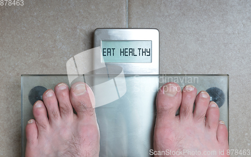 Image of Man\'s feet on weight scale - Eat healthy