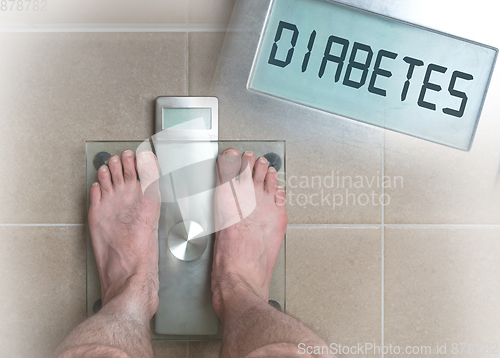 Image of Man\'s feet on weight scale - Diabetes