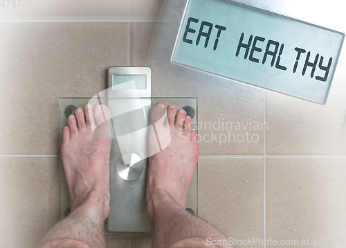 Image of Man\'s feet on weight scale - Eat healthy