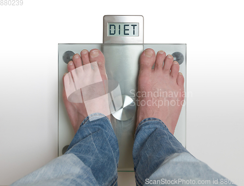 Image of Man\'s feet on weight scale - Diet