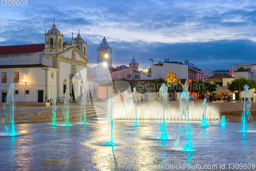 Image of illuminated Lagos cityscape with fountain