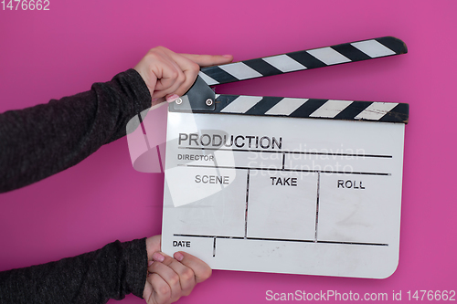 Image of movie clapper on pink background